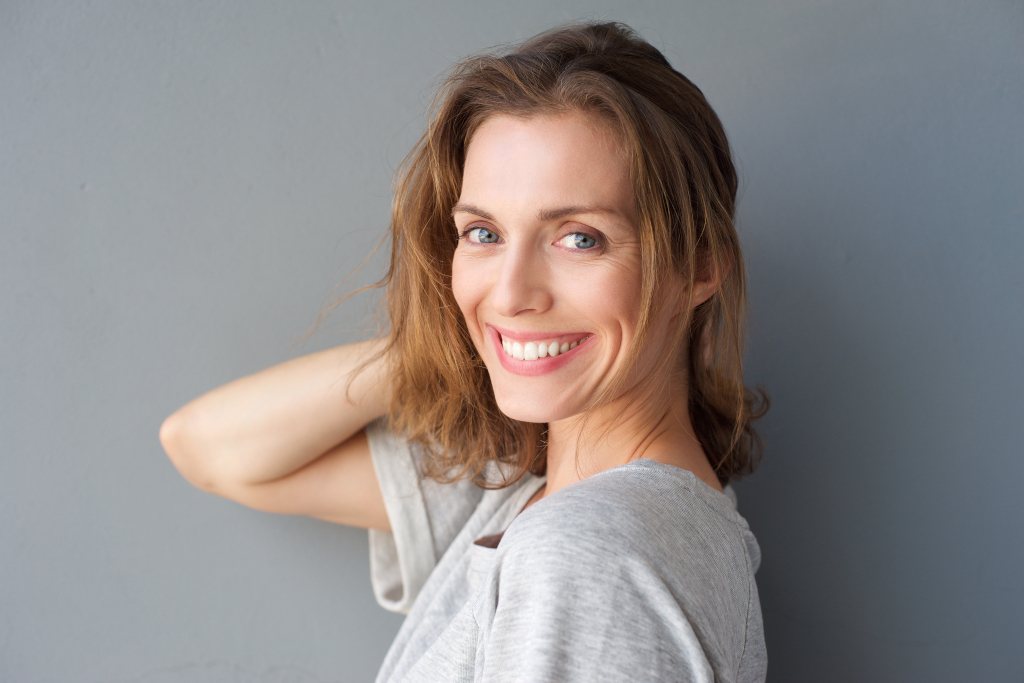 Happy smiling beautiful woman posing with hand